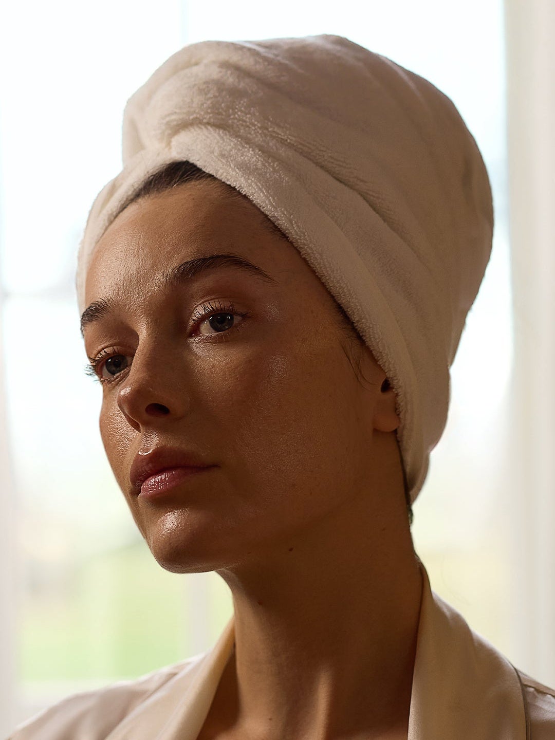 image of model with hair in at towel with dewy skin