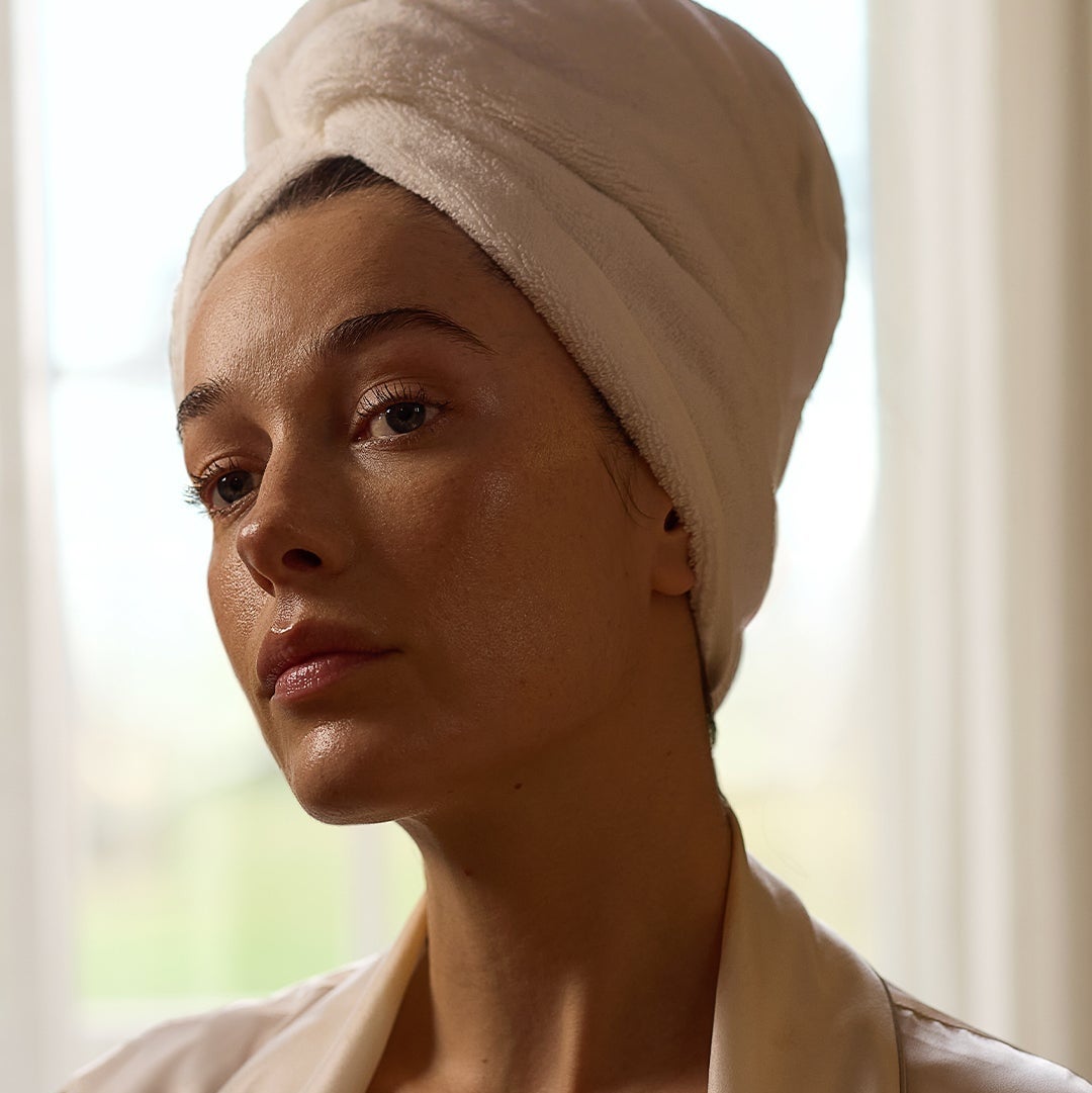 Model with mask on and towel wrapped in a turbin 