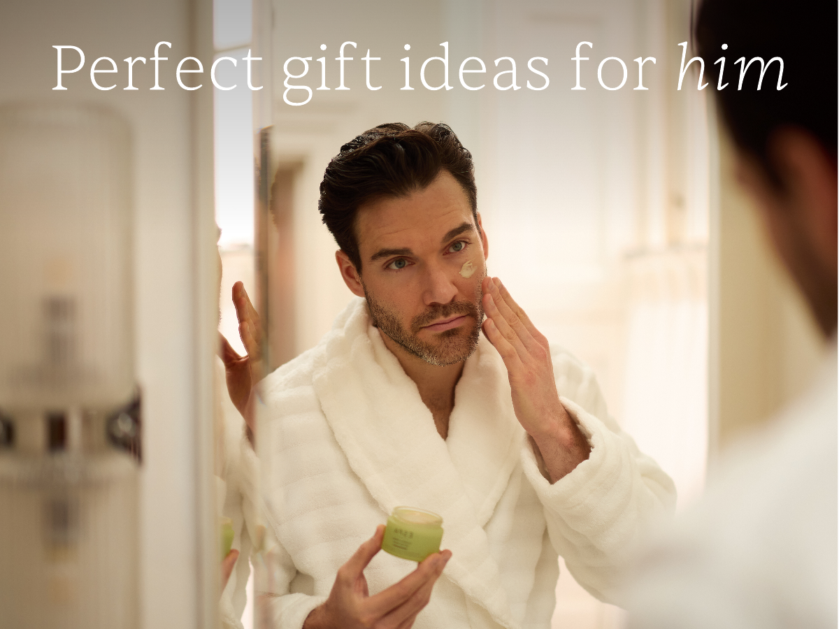 Perfect gifts ideas for him - male model apply moisturiser in the bathroom mirror
