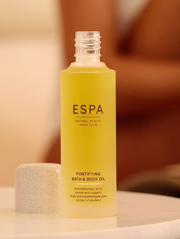 FPRTIFYING BATH AND BODYOIL ON TABLE WITH LID OFF