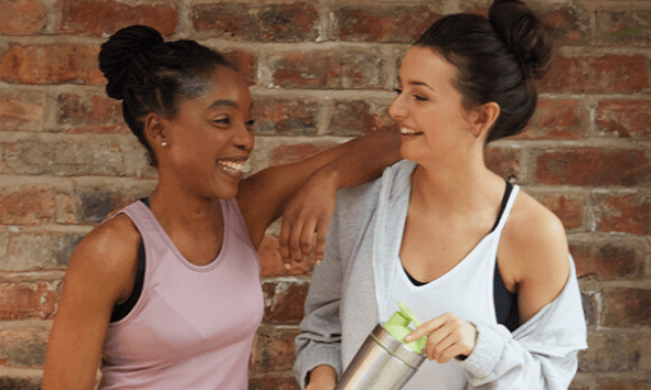 two girls laughing with shaker